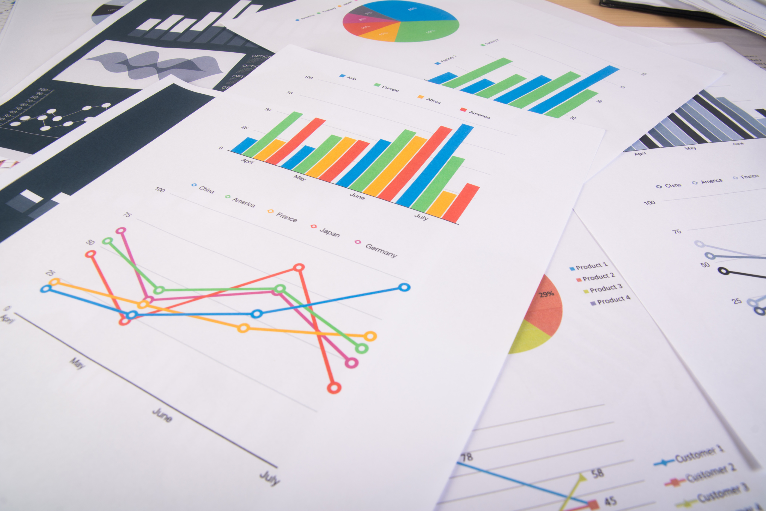 Alt="papers with graphs and curves showing writing essay drafts trends"